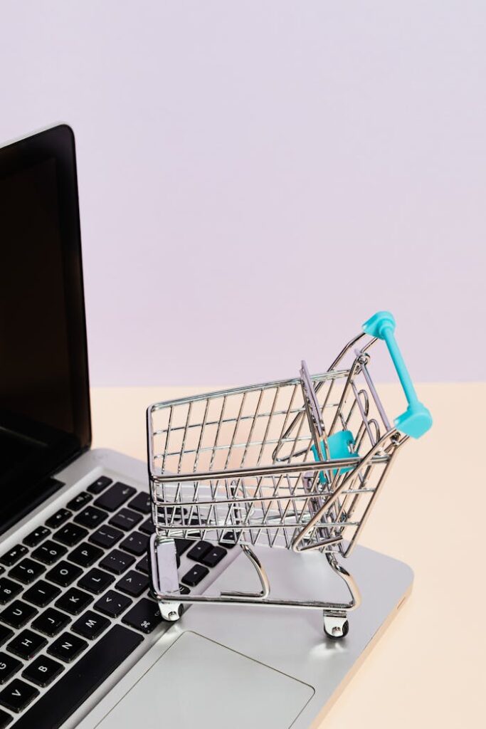 pexels-photo-5632382 Mini shopping cart on a laptop symbolizes online shopping and e-commerce themes.